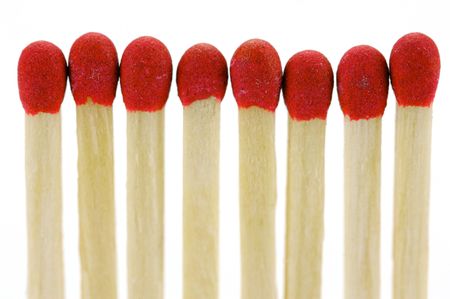 Red head matches isolated against a white backgroundの写真素材