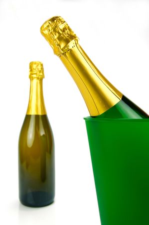 Bottles of sparkling wine in an ice bucket isolated agaisnt a white backgroundの写真素材