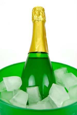 Bottles of sparkling wine in an ice bucket isolated agaisnt a white backgroundの写真素材