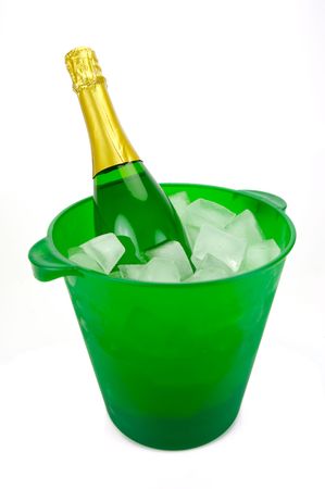 Bottles of sparkling wine in an ice bucket isolated agaisnt a white backgroundの写真素材