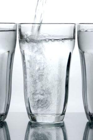 Glasses of drinking water backlit against a white backgroundの写真素材