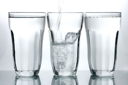 Glasses of drinking water backlit against a white backgroundの写真素材
