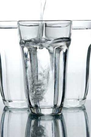 Glasses of drinking water backlit against a white backgroundの写真素材