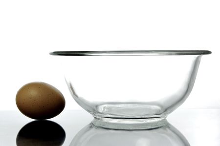 An egg and a glass bowl isolated and backlitの写真素材