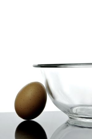 An egg and a glass bowl isolated and backlitの写真素材