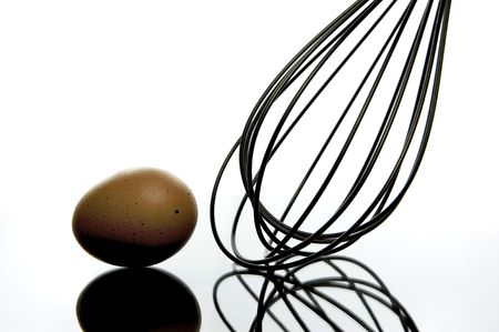 An egg and a whisk isolated and backlitの写真素材