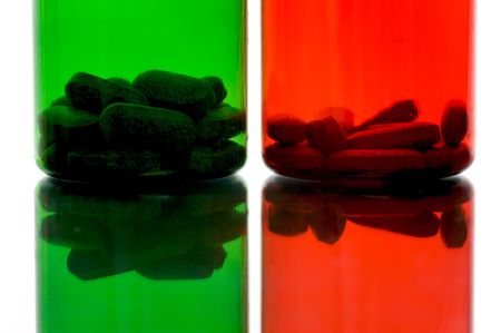 Vitamin tablets in containers isolated and backlitの写真素材