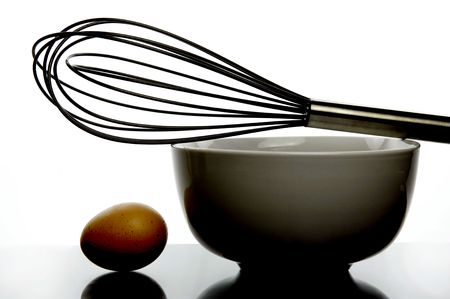 An egg and a glass bowl isolated and backlitの写真素材