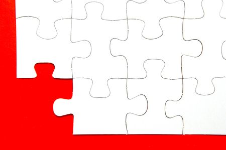 Pieces of jigsaw puzzle isolated against a red backgroundの写真素材