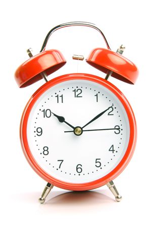 An old fahion analogue alarm clock set against a white backgroundの写真素材