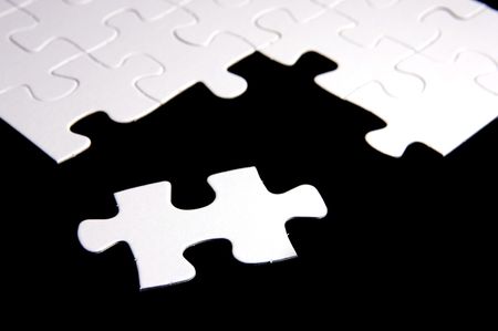 Jigsaw pieces isolated against a black backgroundの写真素材