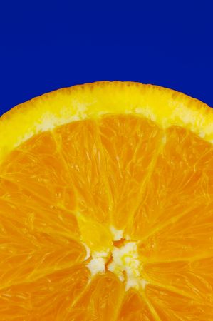 A sliced orange isolated against a blue backgroundの写真素材