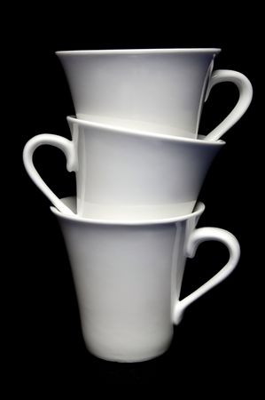 Tea cups isolated against a black backgroundの写真素材
