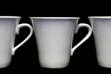 Tea cups isolated against a black backgroundの写真素材