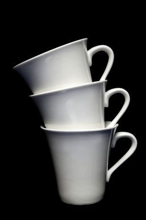 Tea cups isolated against a black backgroundの写真素材