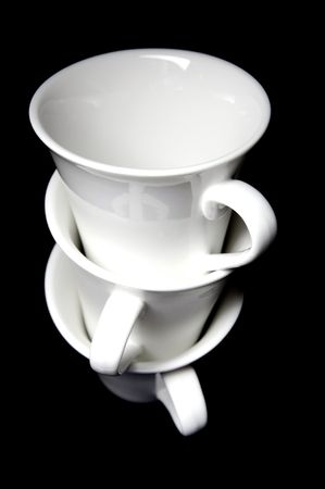 Tea cups isolated against a black backgroundの写真素材