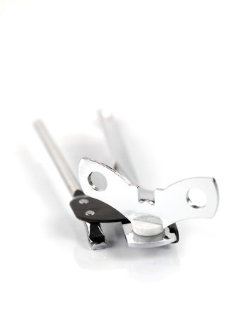 A can opener and a tin can isolated against a white backgroundの写真素材