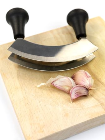 Garlic on a cutting board isolated against a white backgroundの写真素材