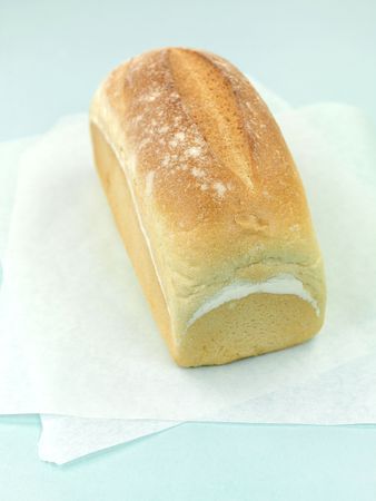 A loaf of bread isolated against a blue backgroundの写真素材