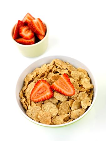 A bowl of breakfast cereal and strawberries isolated against a white background