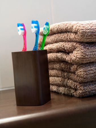 Toothbrushes in toothbrush holder in a bathroomの写真素材