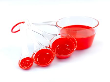 Measuring cups isolated against a blue backgroundの写真素材