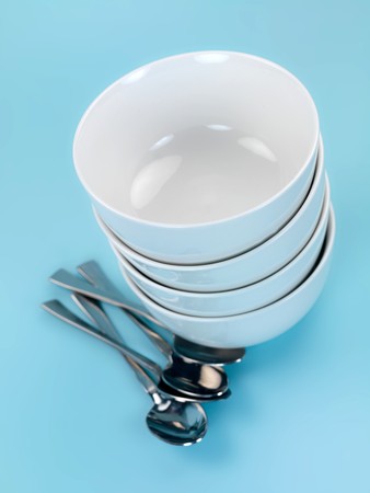 Plates and cutlery isolated against a blue backgroundの写真素材