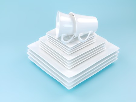 Plates and cutlery isolated against a blue backgroundの写真素材