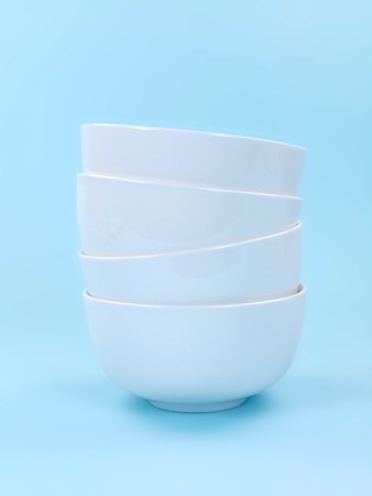 Plates and cutlery isolated against a blue backgroundの写真素材