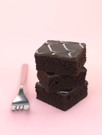 Chocolate mud cake slices isolated against a pink backgroundの写真素材