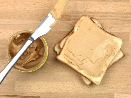 A slice of white bread with peanut butterの写真素材