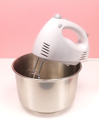 An electric hand mixer on a kitchen benchの写真素材