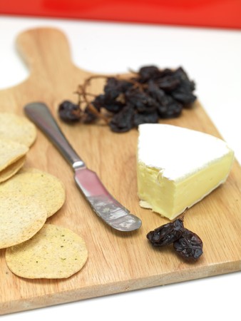 A selection of cheeses on a cutting boardの写真素材