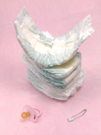 A stack of modern disposable nappies isolated against a pink backgroundの写真素材