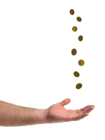 A hand catching falling coin isolated against a white backgroundの写真素材