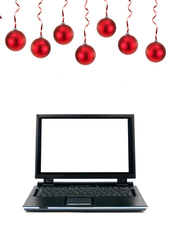 A laptop computer with christmas ornaments isolated against a white backgroundの写真素材