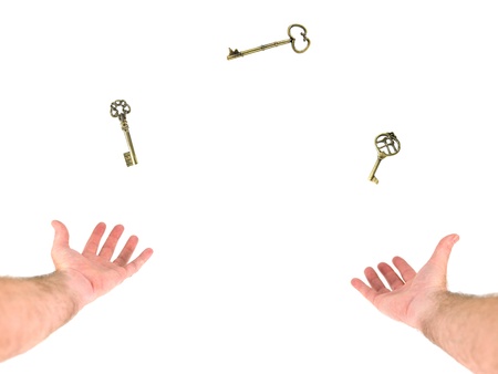 A person juggling keys on a white backgroundの写真素材