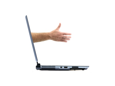 Male hands forming a handshake out of a laptopisolated against a white backgroundの写真素材