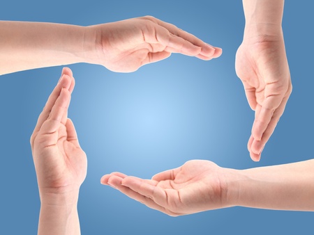 Female hands making a shape for protectionの写真素材