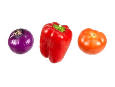 A red onion, capsicum and tomato isolated against a white backgroundの写真素材