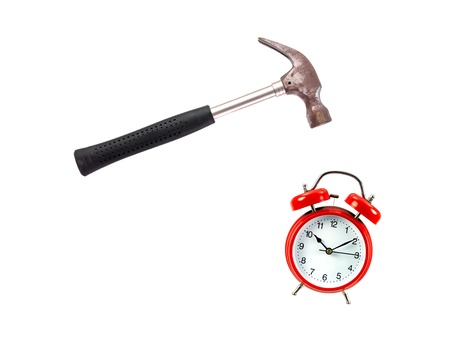 An alarm clock and a hammer isolated against a white backgroundの写真素材