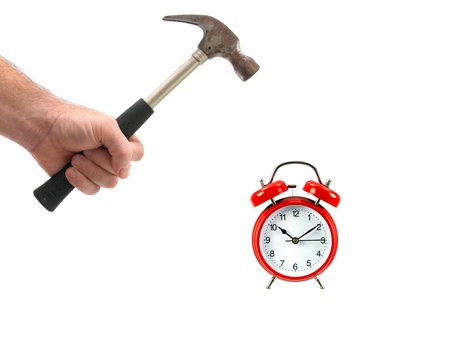 An alarm clock and a hammer isolated against a white backgroundの写真素材