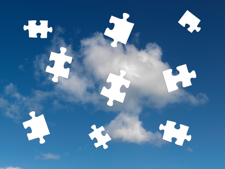 A morning shot of a cloudy blue sky with jigsaw piecesの写真素材