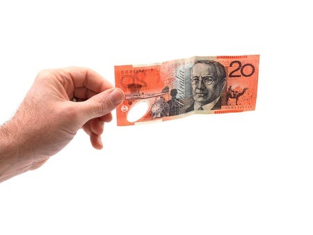 A hand holding cash isolated against a white backgroundの写真素材