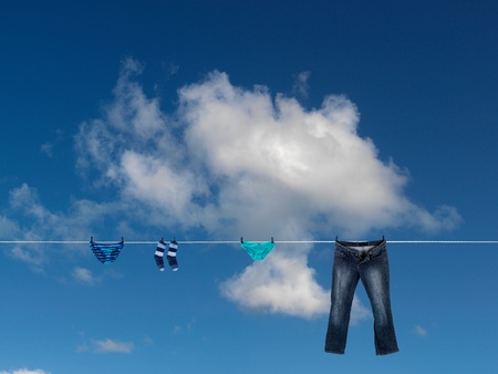 Clothes on a clothes line isolated against a blue skyの写真素材