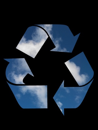 A recycle symbol cutout on a blue skyの写真素材
