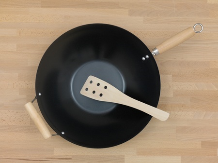 A wok on a wooden kitchen benchの写真素材