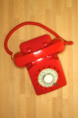 A vintage rotary telephone on a deskの写真素材