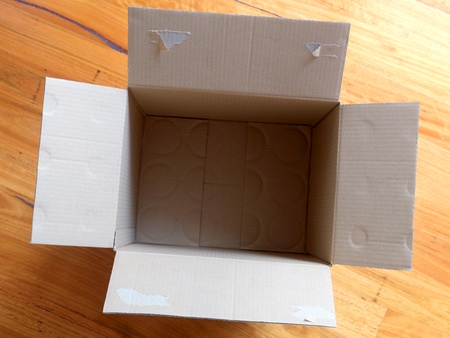 Cardboard boxes isolated on a wooden floor