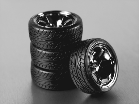 Rubber tyres with sports rims on a silver backgroundの写真素材